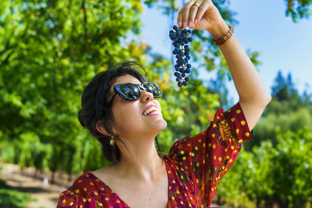 business branding photo of a woman holding grapes close to her mouth