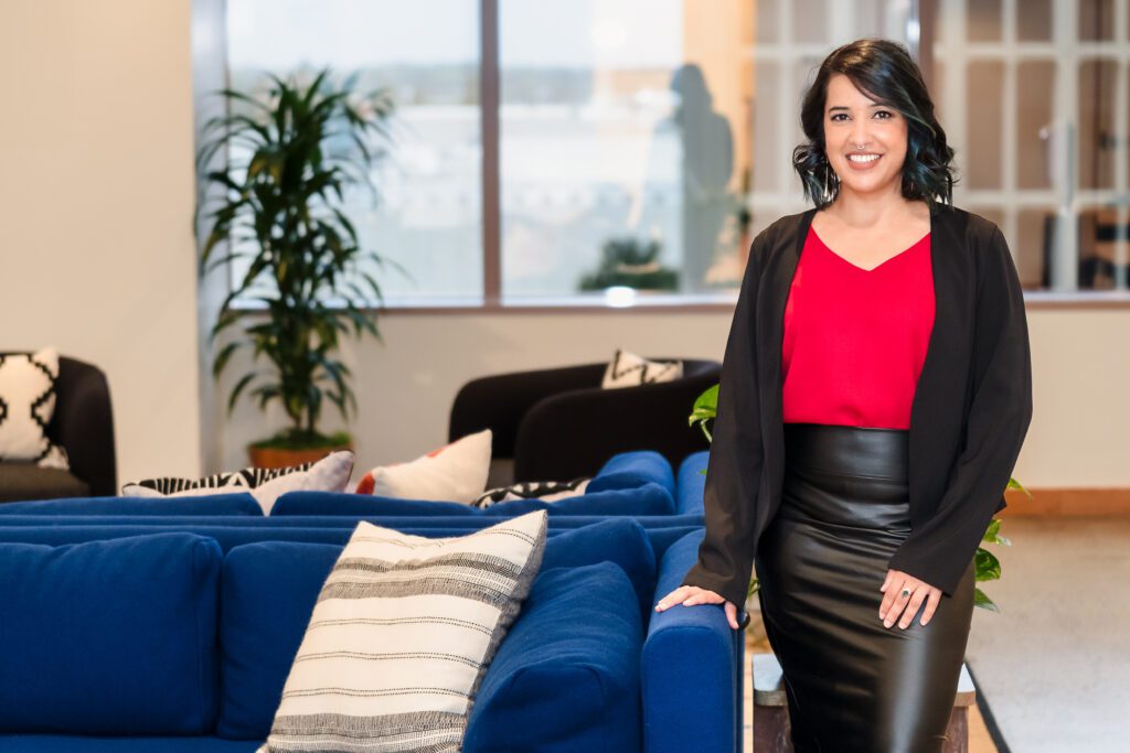 woman stands in a co-working space in Sacramento for her brand session