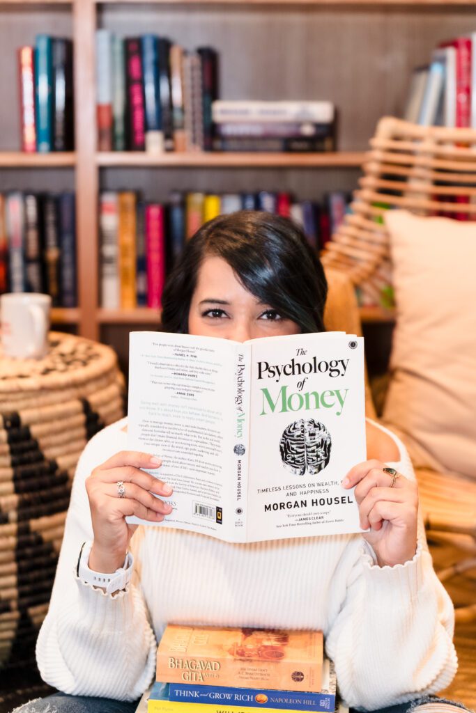 business coach holding a book in front of her face