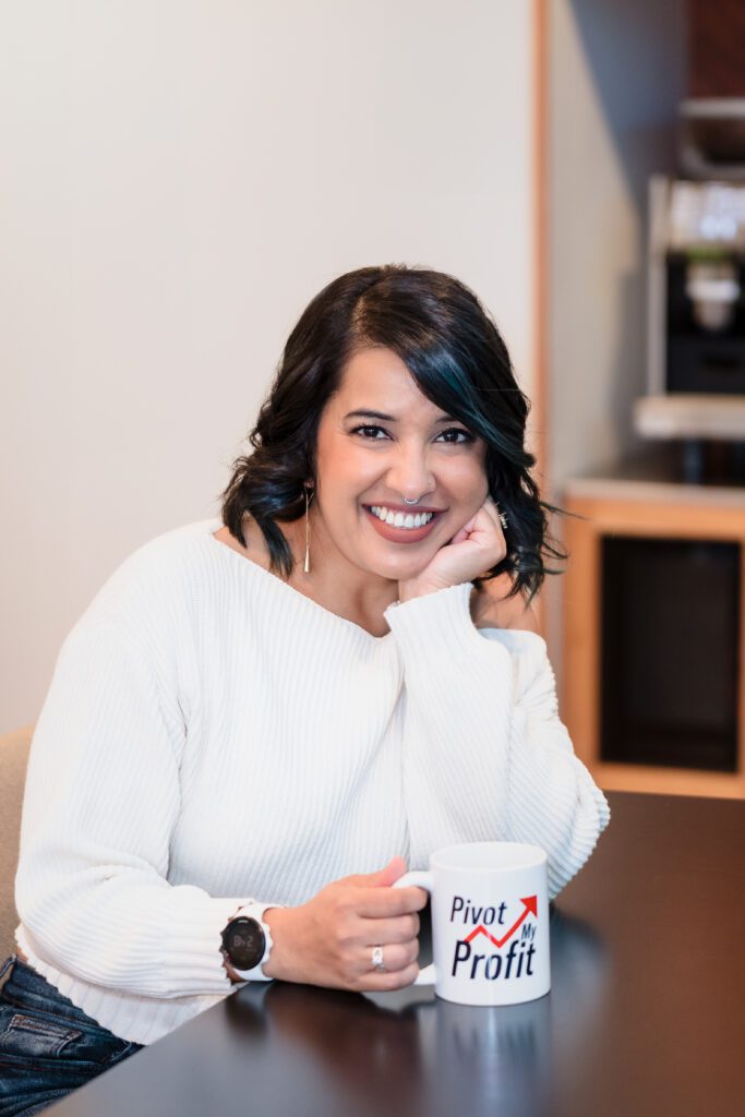 brand photo of a business coach sitting at a desk posing with an on-brand coffee mug