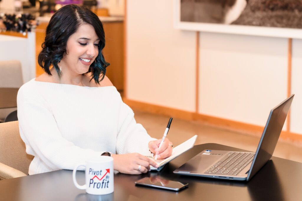 brand photo of a financial strategist working on notebook and laptop