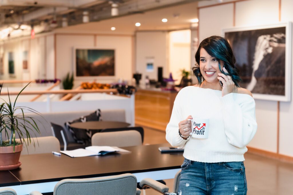 business strategist on the phone, holding an on-brand coffee mug