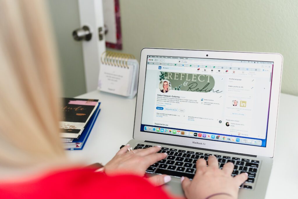 detail shot of a life coach typing on the laptop opened on the business website
