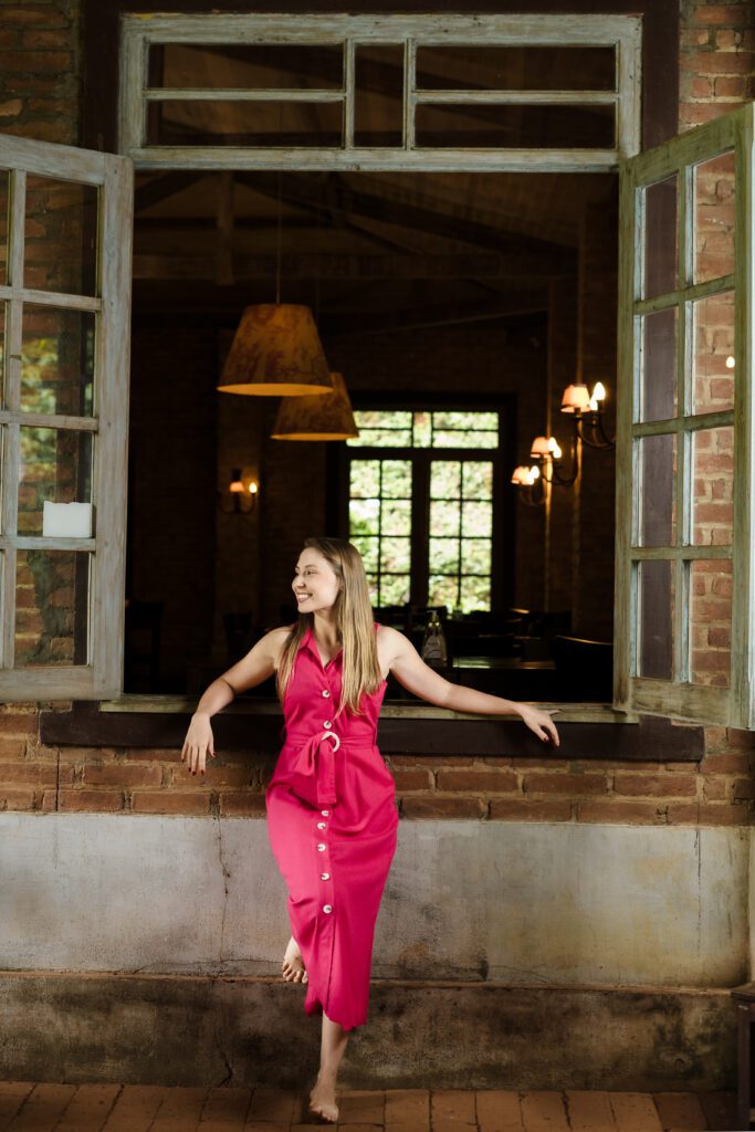 woman leans on a huge window of a restaurant - lifestyle shot for her personal brand