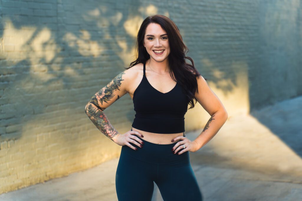 woman posing in a workout outfit, arms in the waist