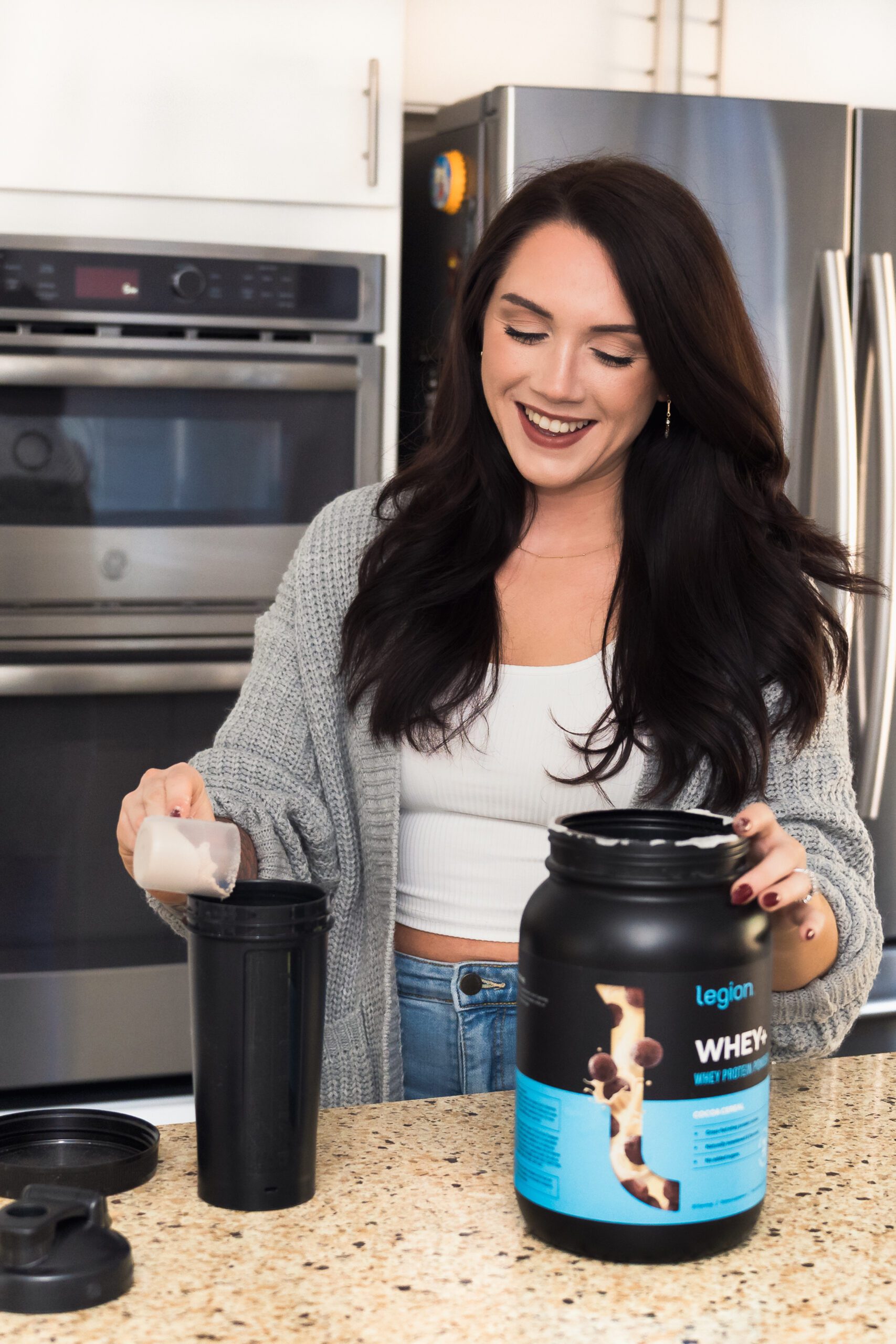 brand photo of a fitness coach preparing a protein shake