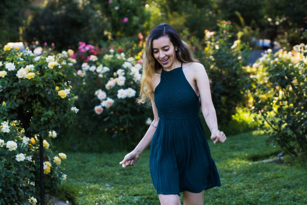 brand photo of a woman dancing in the park.