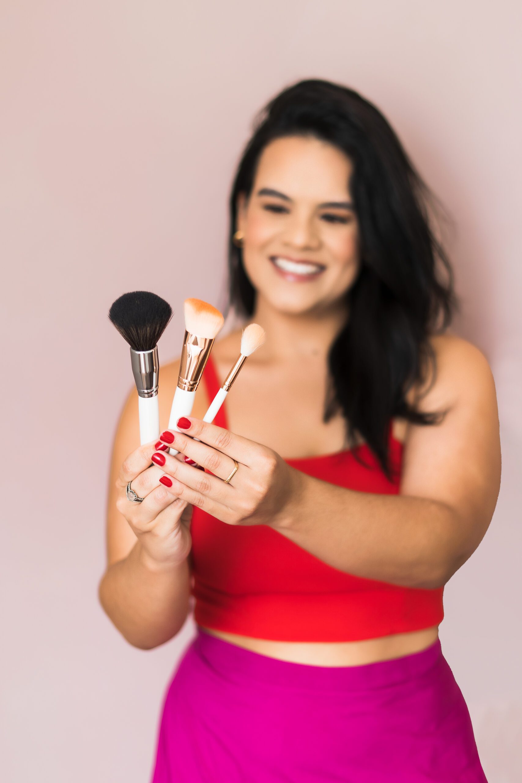 makeup artist holding brushes