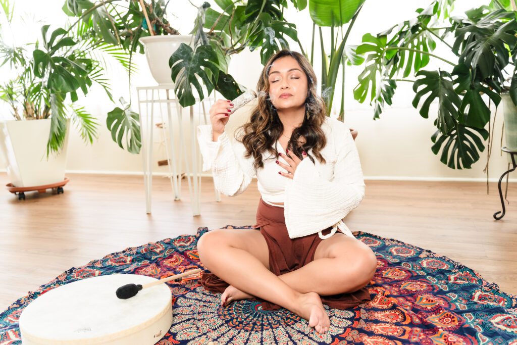 brand photo of a life coach in a meditation pose burning sage