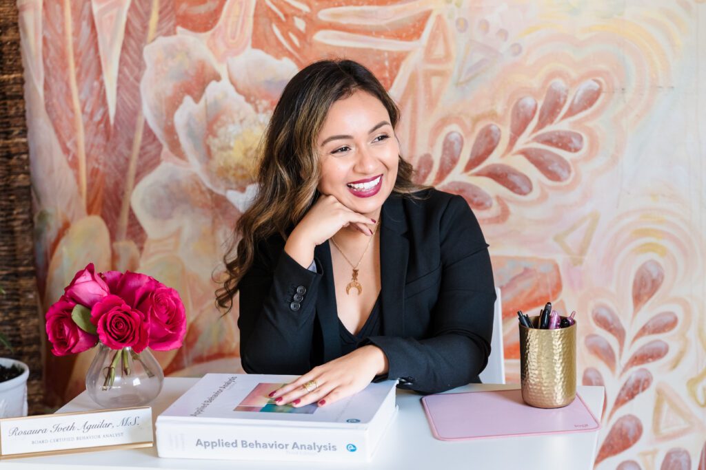 life coach in her office, looking away to the camera, hand in her chin