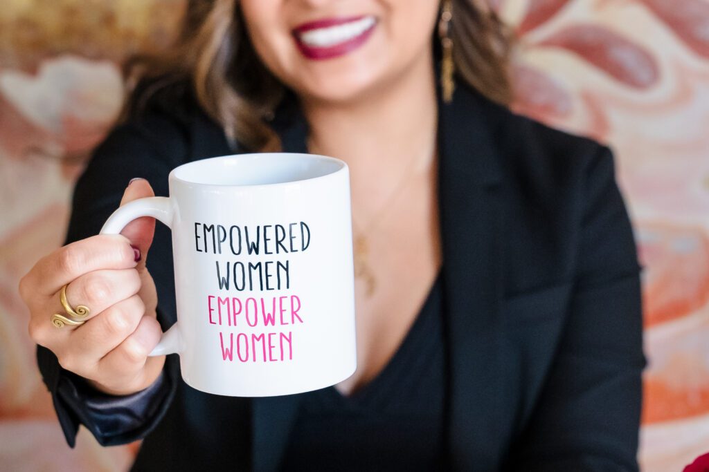 the brand image of a female entrepreneur holding a coffee mug with the quote 'Empowered women empower women'