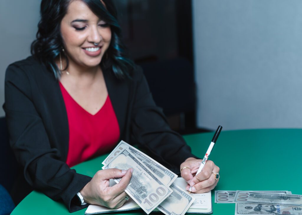 brand photo of a business coach holding dollar cash
