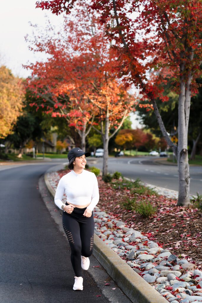 brand photo of a woman running during the fall