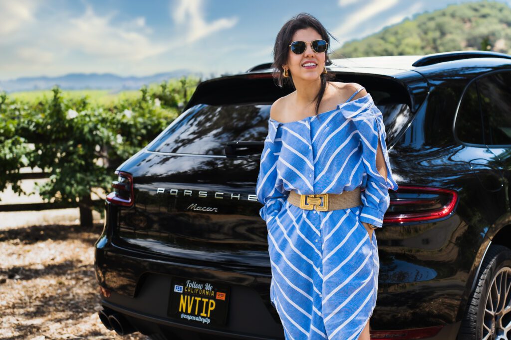 brand photo of a tour guide in Napa Valley leaning on her brand car
