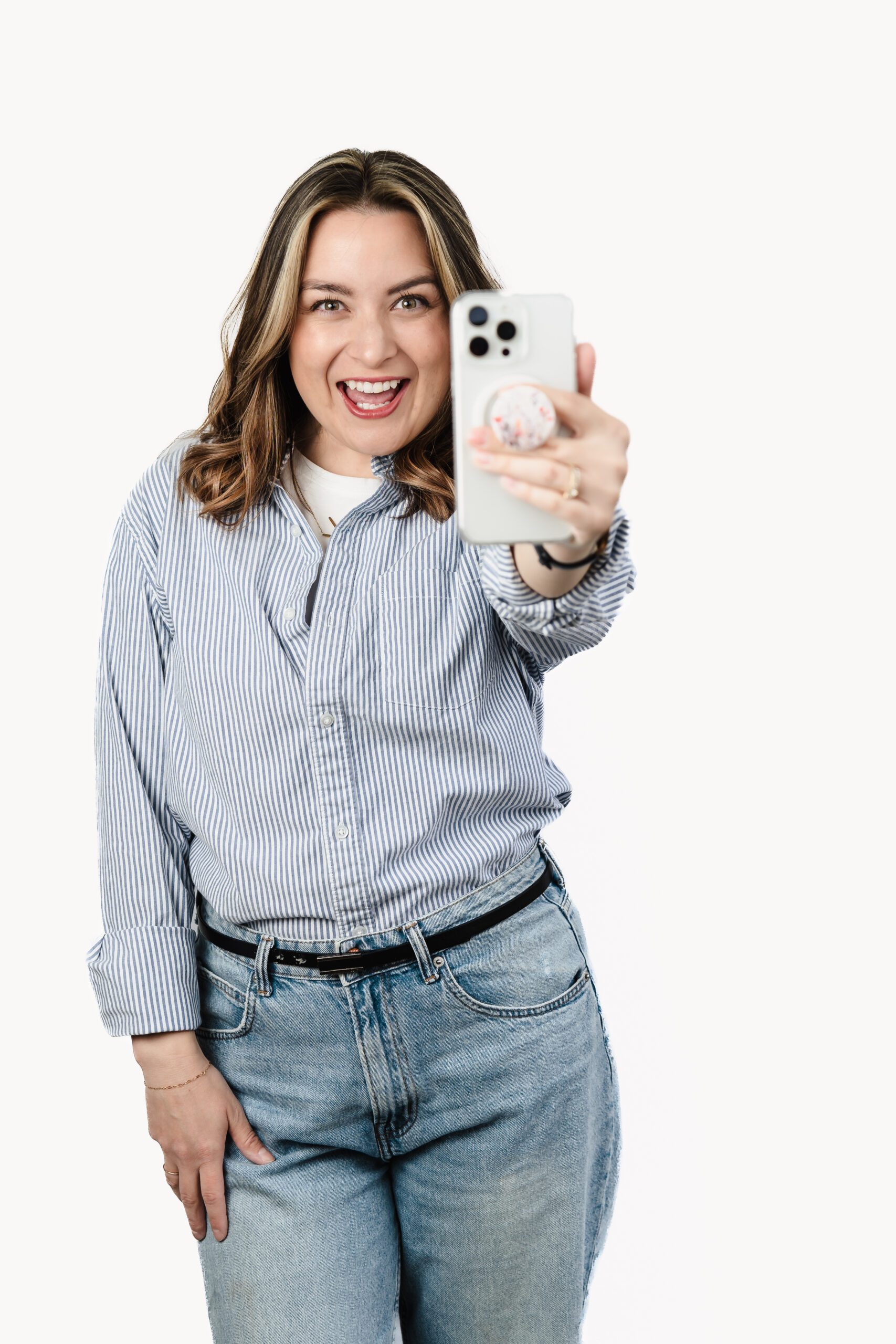 brand photo of content creator with her phone posing for a brand headshot