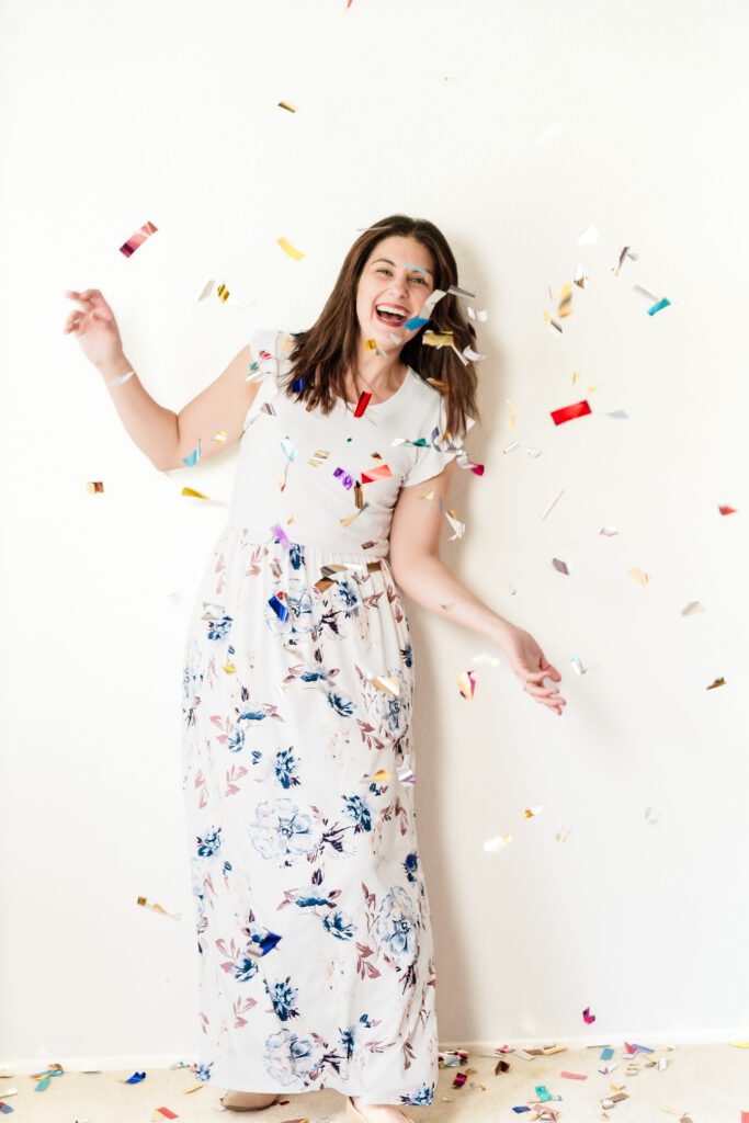 brand photo of a balloon business owner throwing confetti