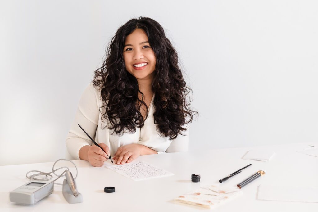 brand headshot for a calligrapher with her tools of the trade