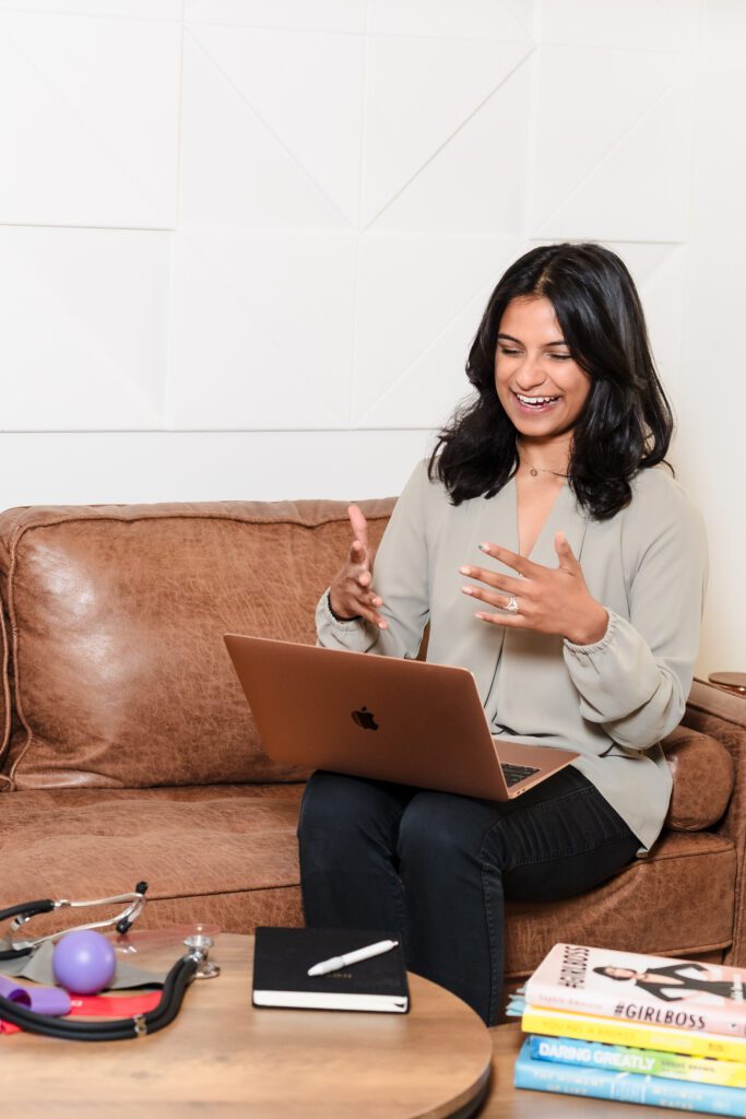 woman in a zoom call with a client, laptop in her lap