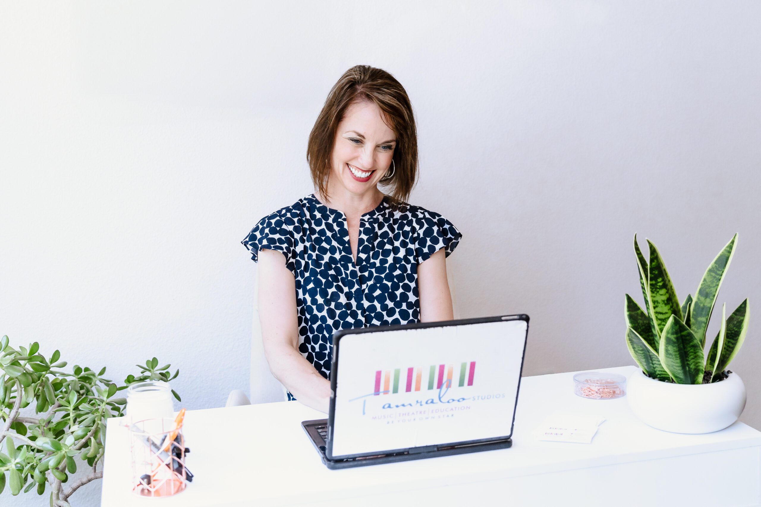 woman looking at her laptop and smiling