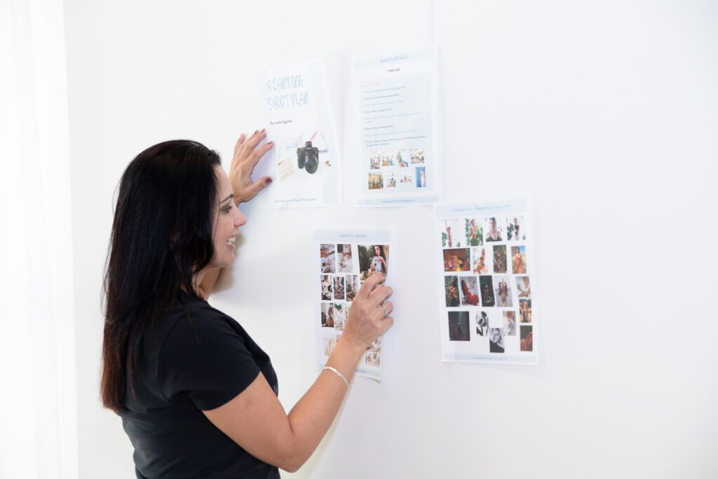 brand photographer placing a Moodboard Inspiration on a white wall