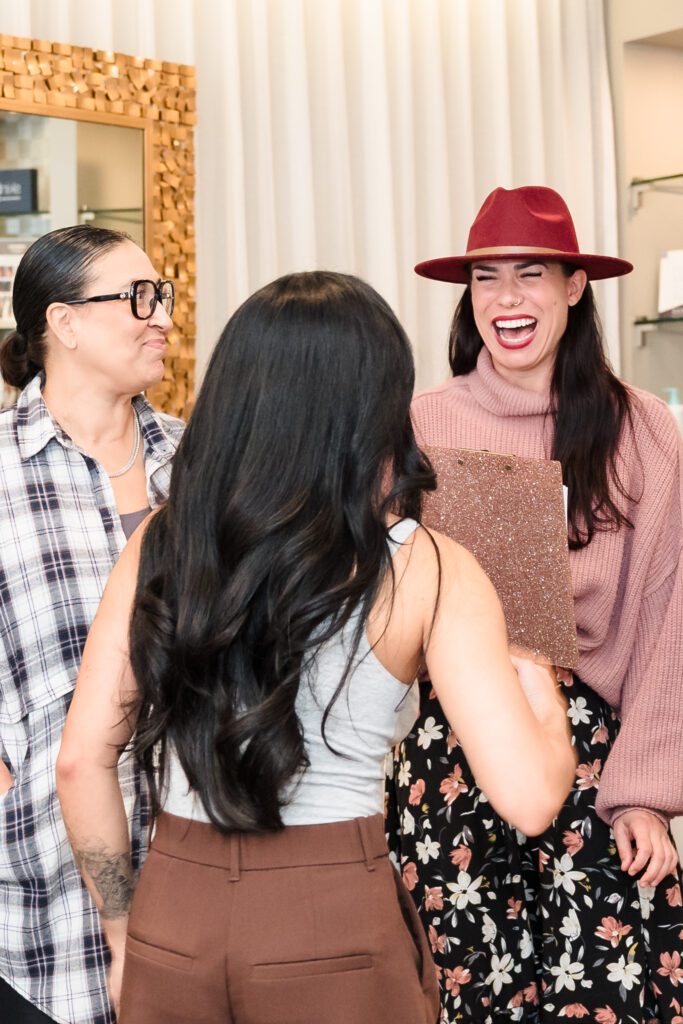 Laughter and real connection among women entrepreneurs at a Sacramento wellness networking event, hosted by Powered by Women and Destination Aesthetic.