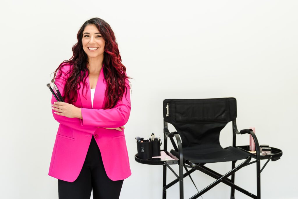 makeup artist posing beside the makeup chair