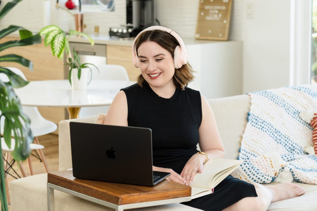 Content Creator working on her laptop, seated on the couch