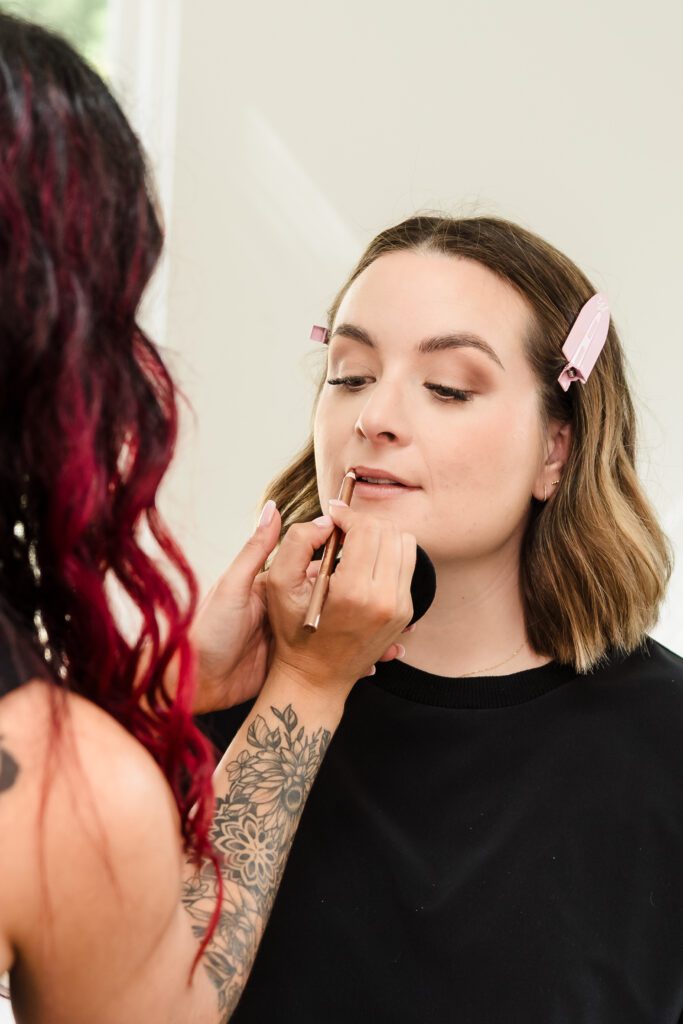 make-up artist applying makeup in a brand photoshoot