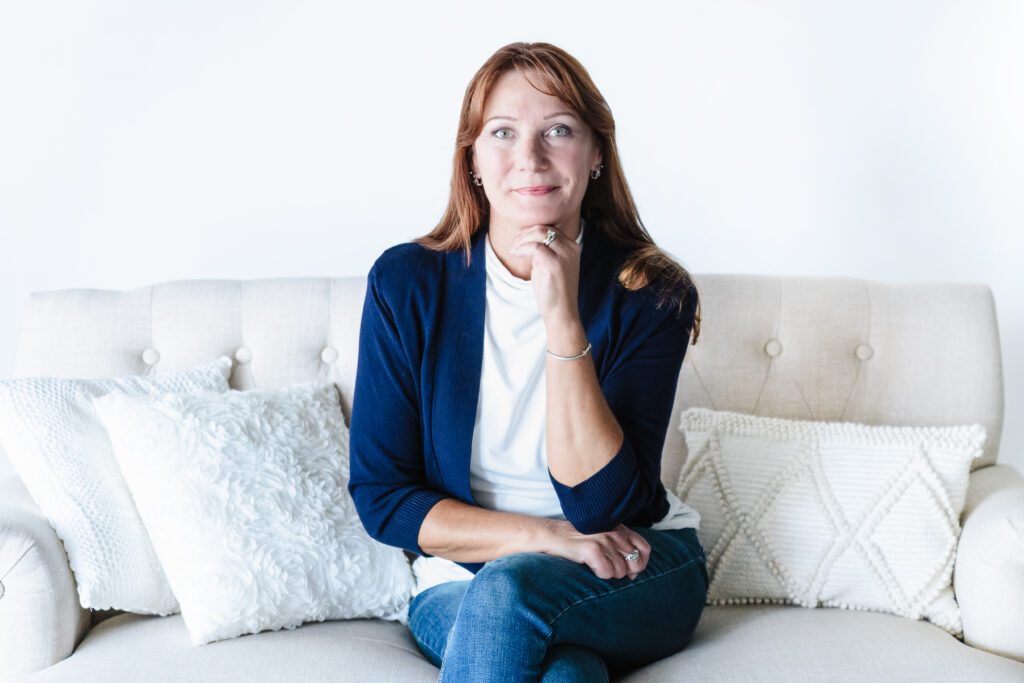 Professional woman smiling during modern lifestyle headshot session in bright studio