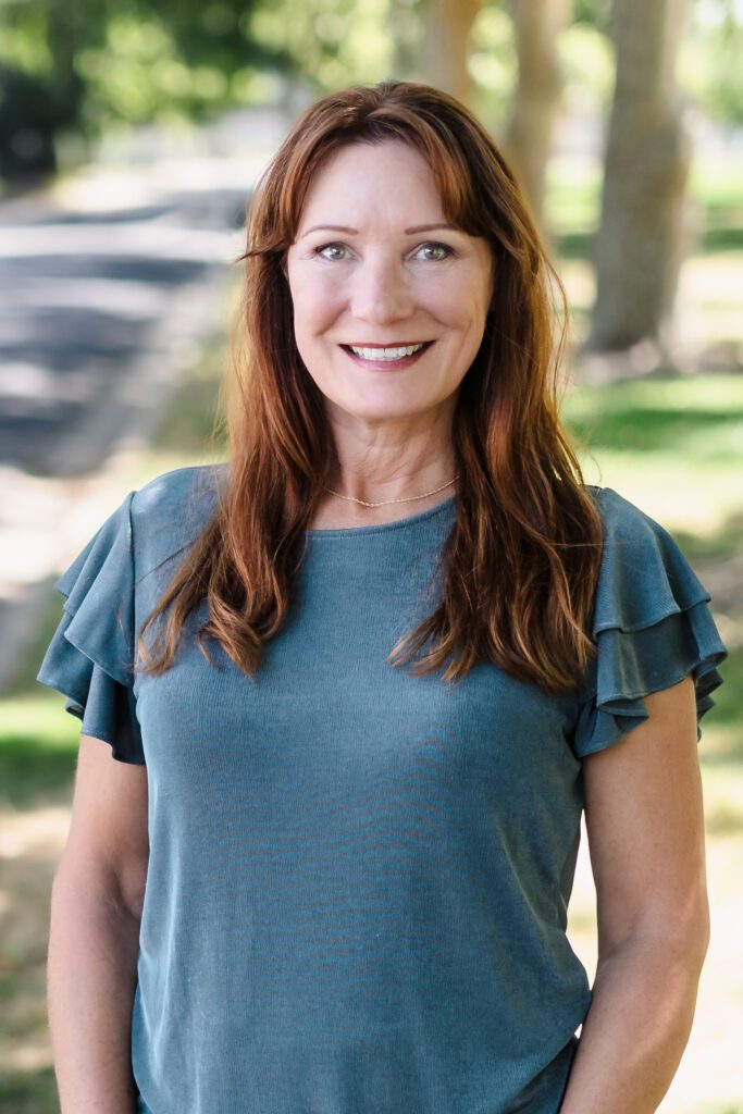 Confident female entrepreneur posing in natural light for lifestyle headshot