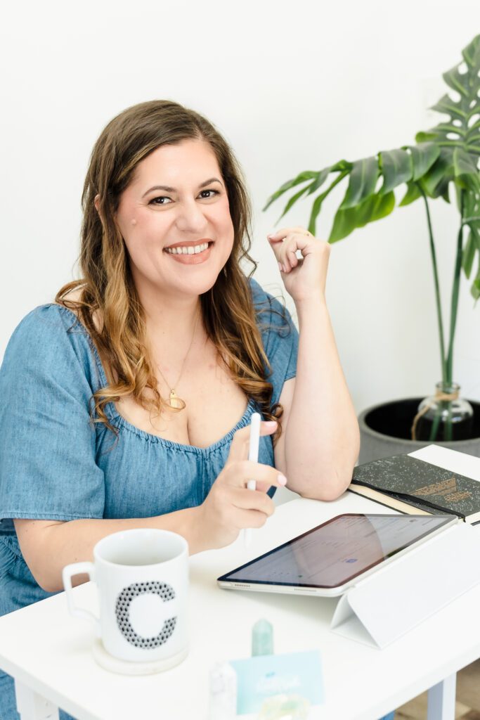 Lifestyle headshot of Sacramento web designer in a styled workspace